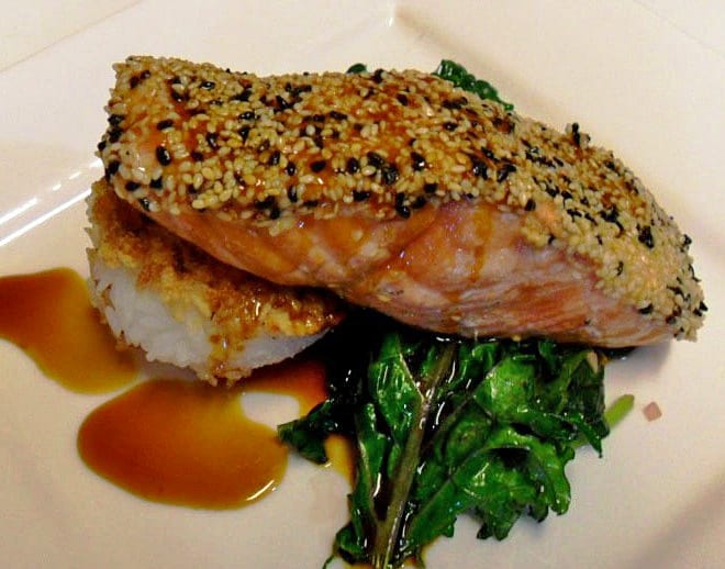 cooked fish plated with greens and rice