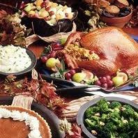 table cluttered with thanksgiving turkey and sides