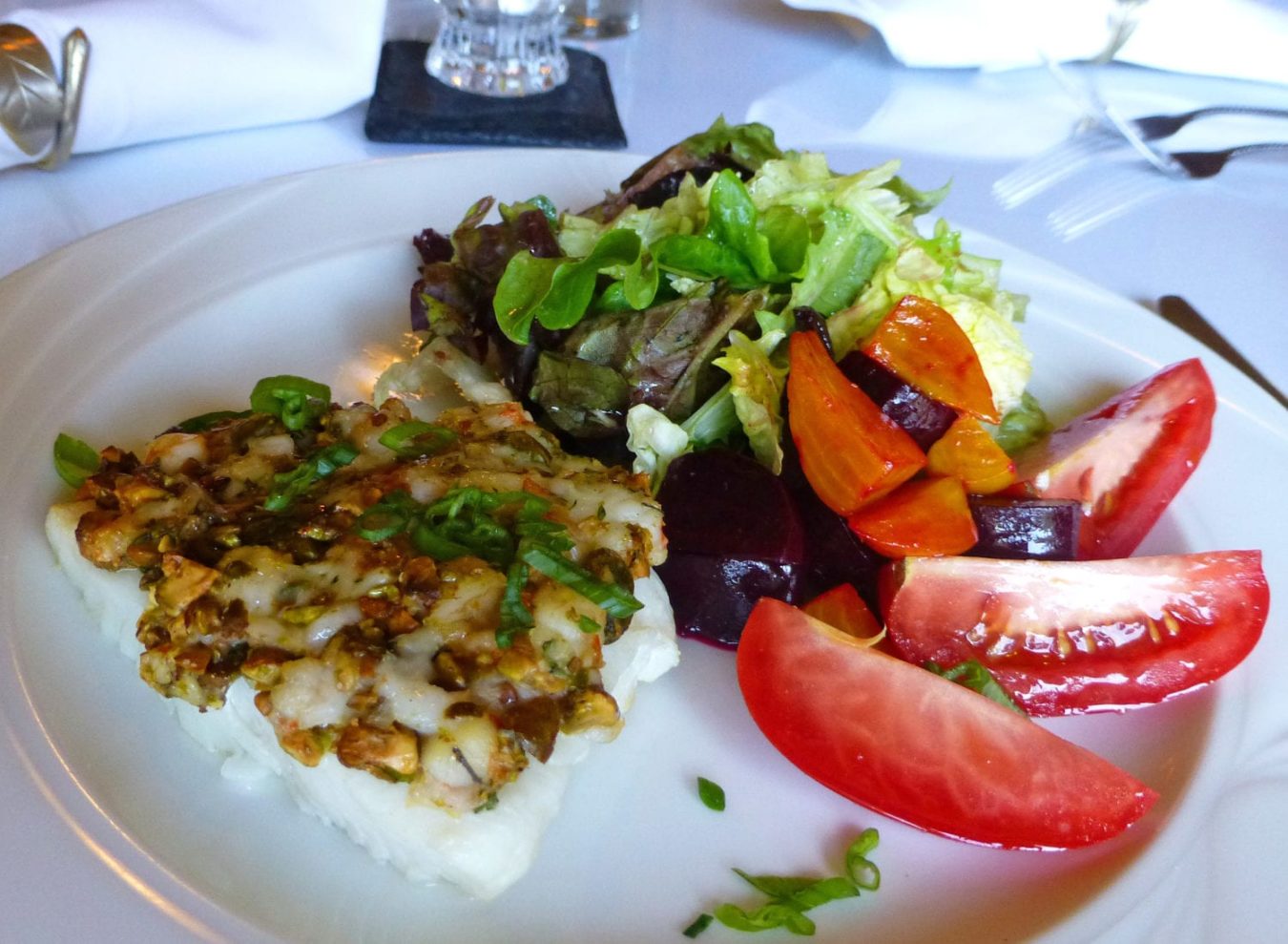 Halibut served with salad of greens, beets, and tomatoes