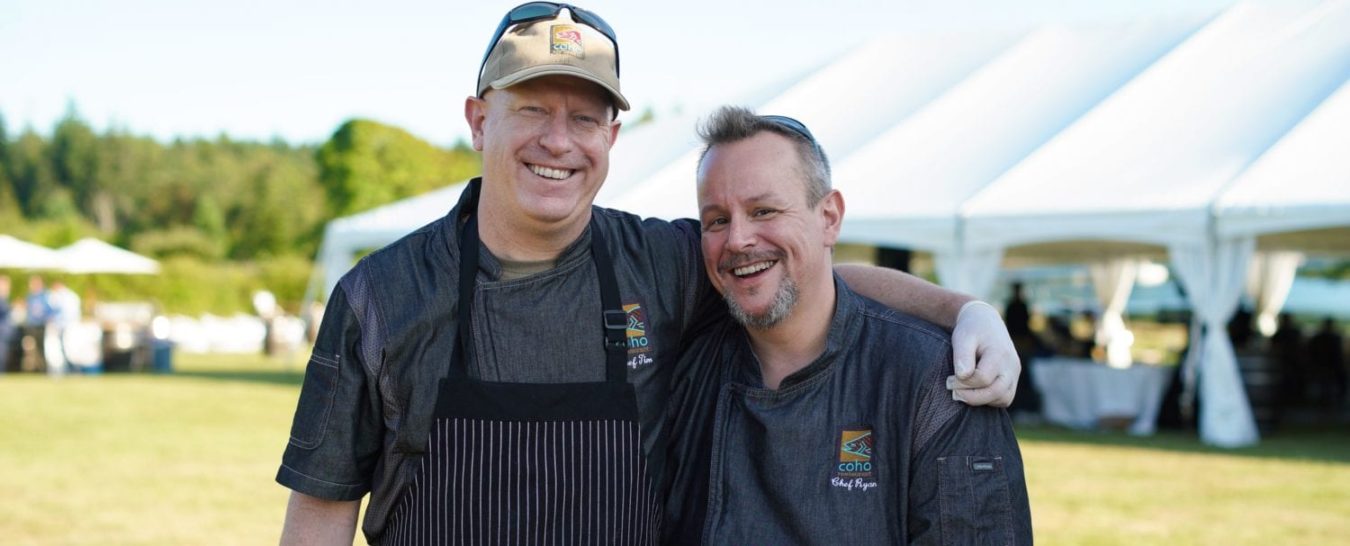 Two chefs pose for a picture at a culinary event