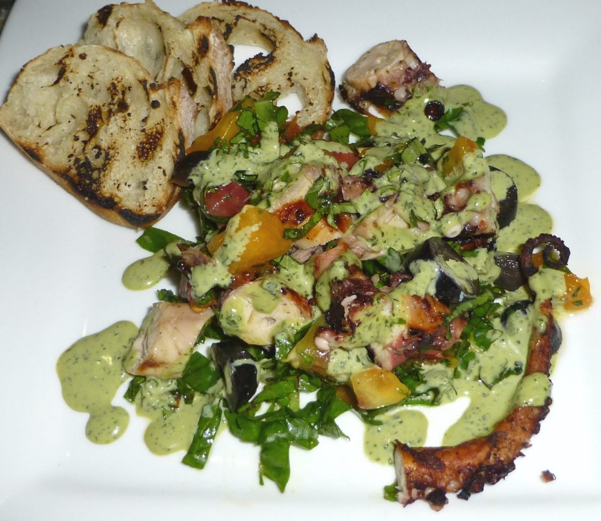 dressed grilled octopus with small toasts