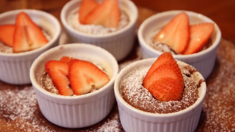 Chocolate Soufflés topped with sliced strawberries