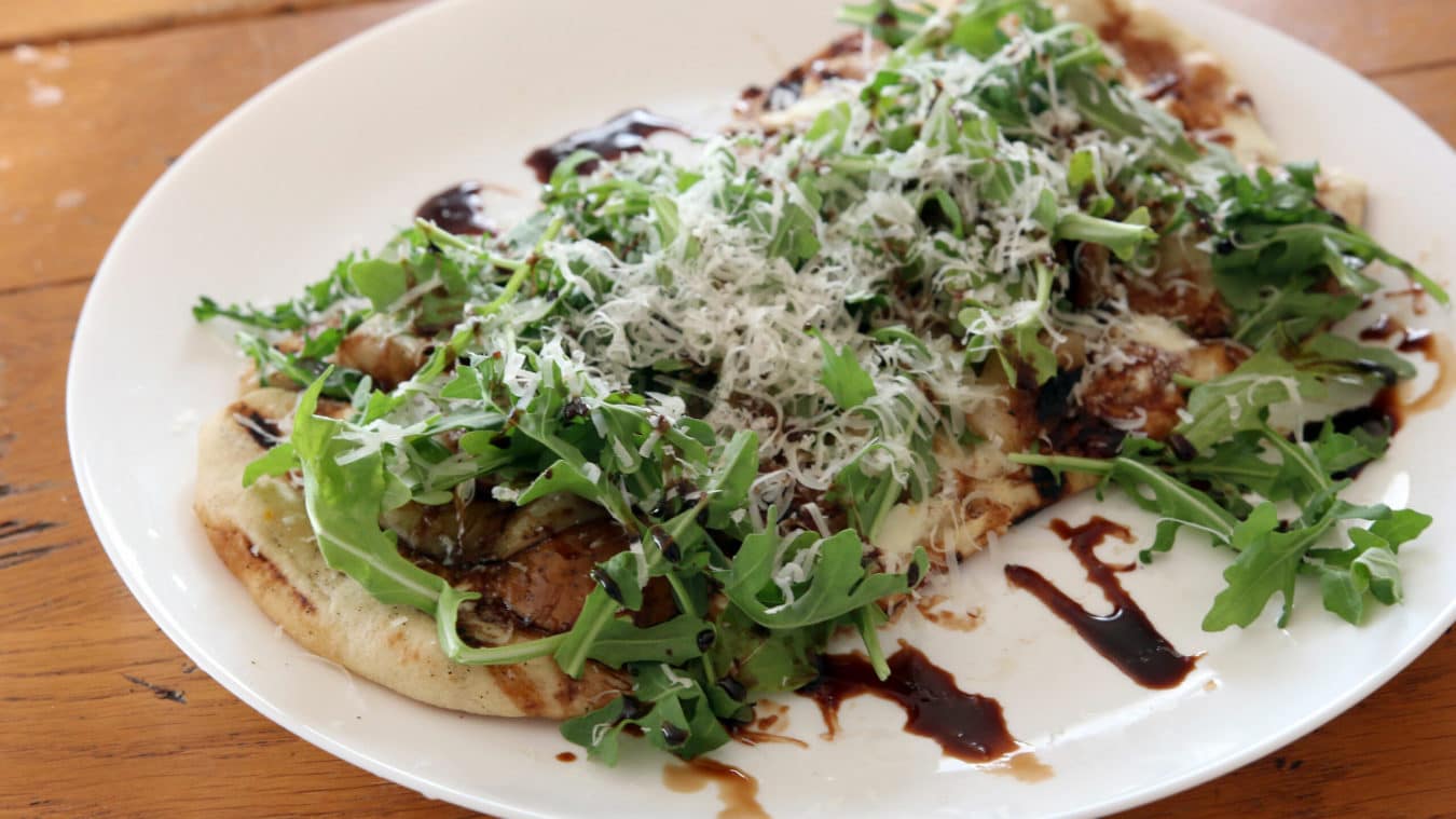 flatbread topped with arugula