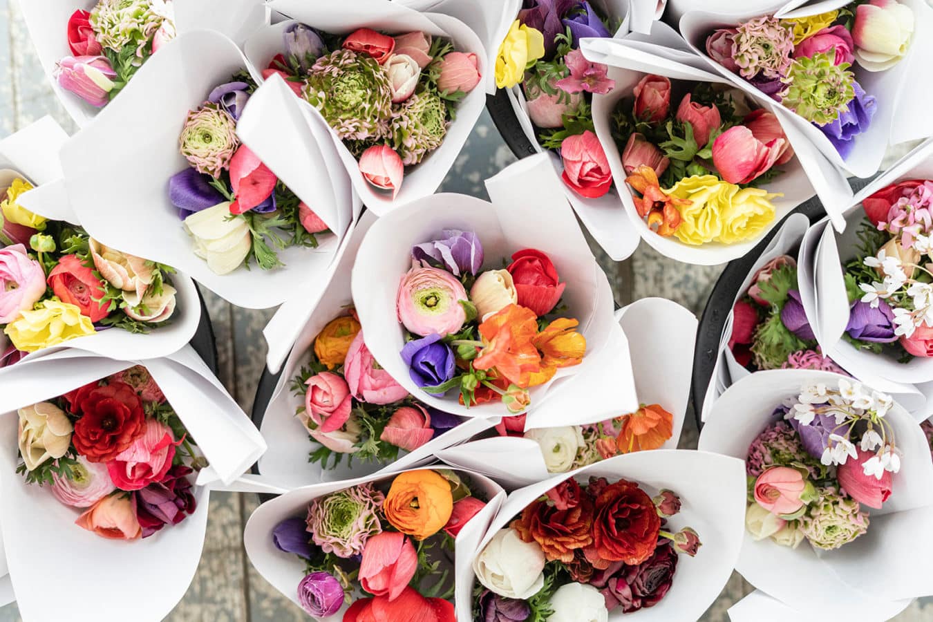 overhead view of flower bouquets wrapped in white paper