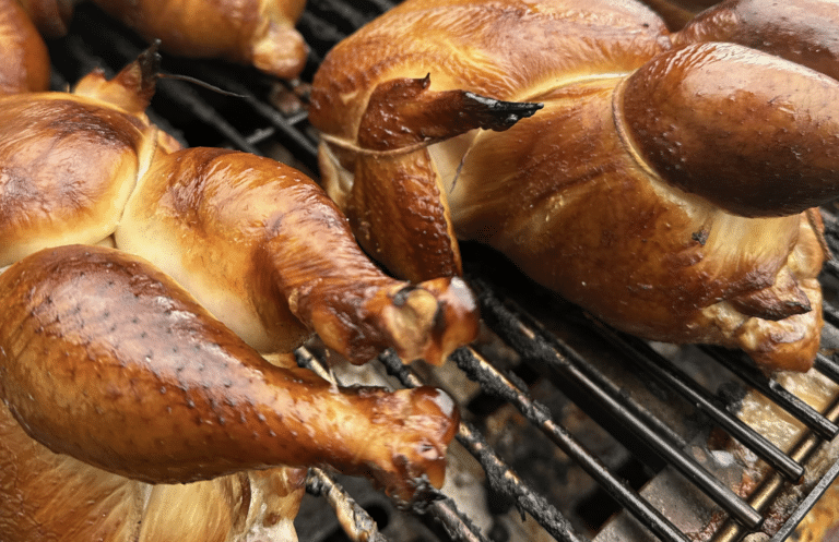 rotisserie chickens on a grill
