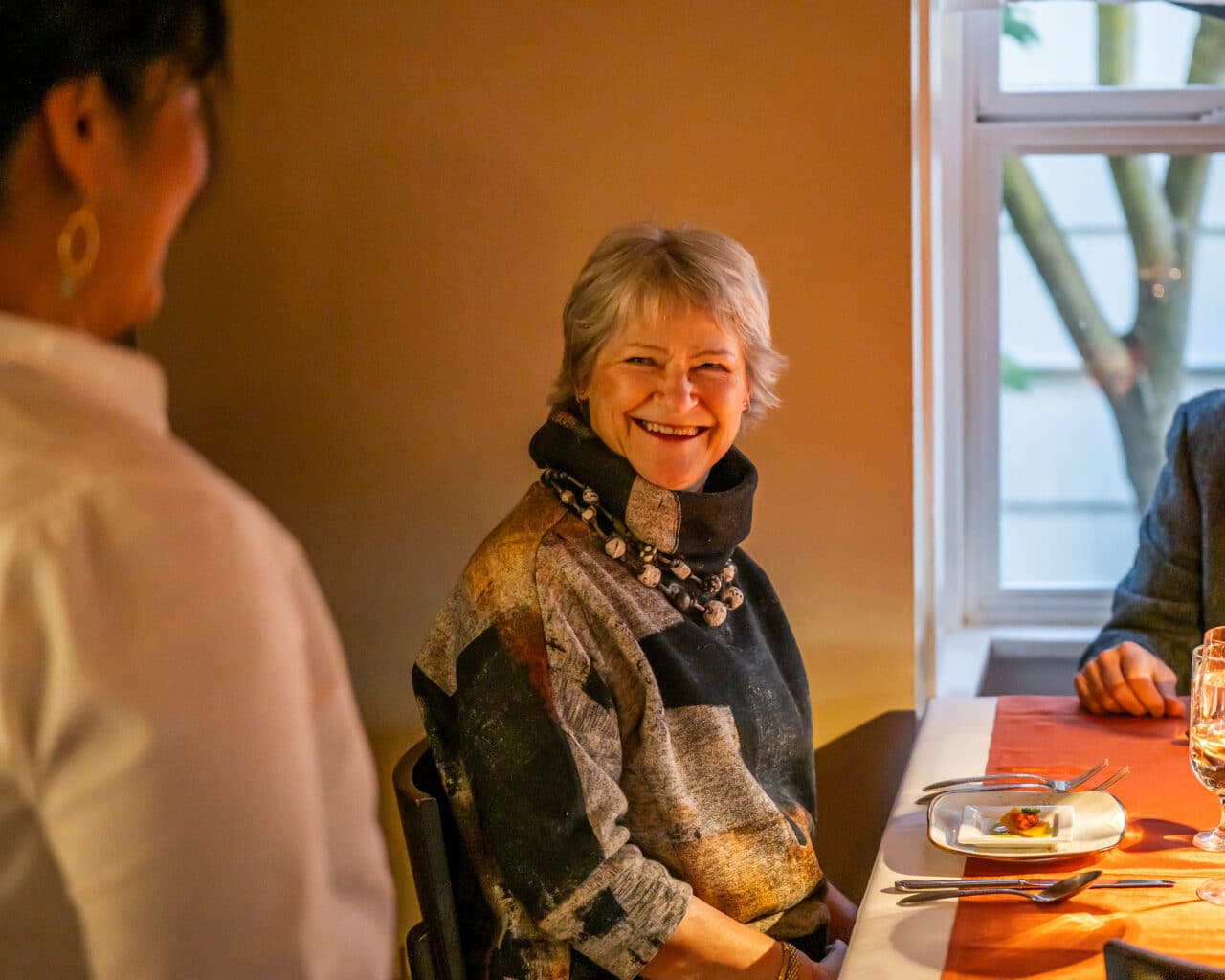 woman seated at dining table